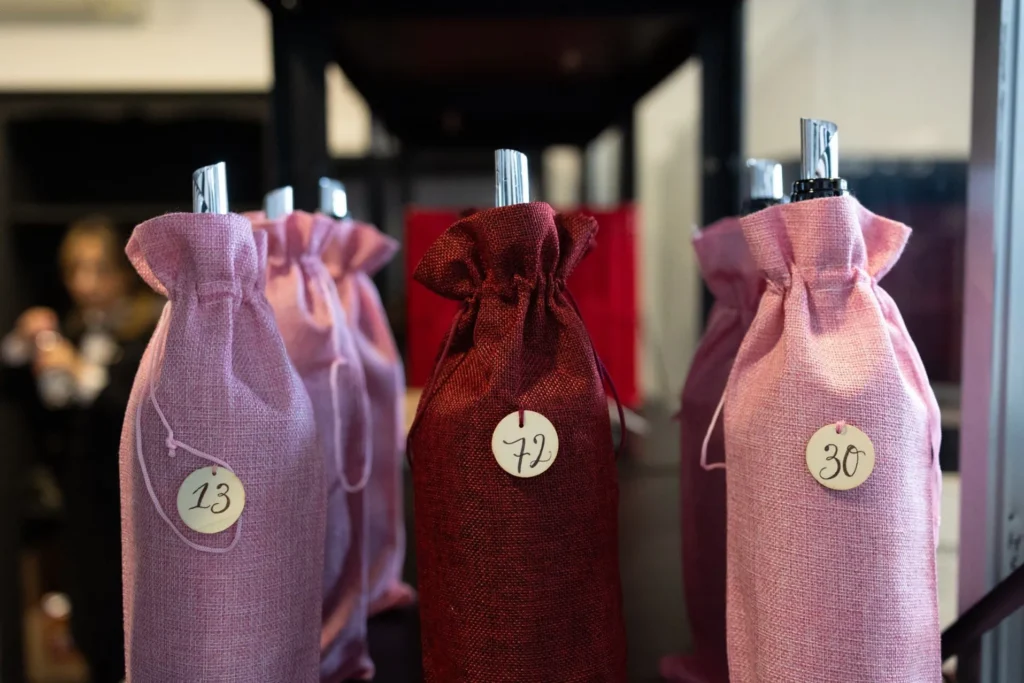 Immagine delle bottiglie ricoperte dalle calze per renderle anonime durante la degustazione delle commissioni di valutazione per la guida Untold