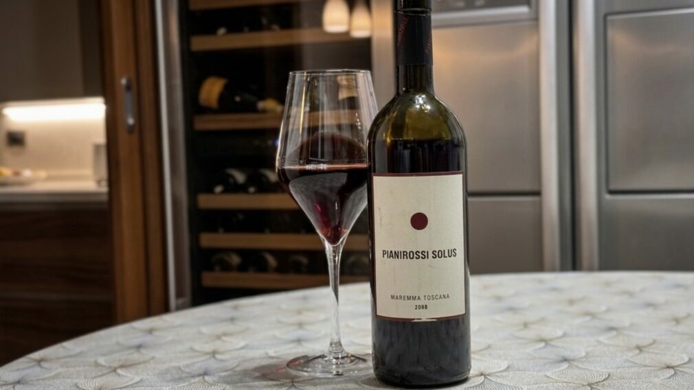 Bottle of Solus Pianirossi 2008 wine with glass of wine.